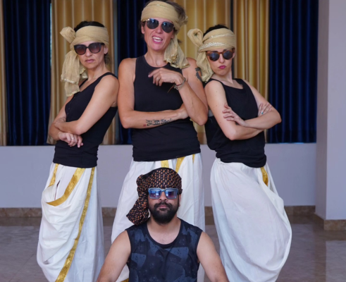 Students performing classical dance on stage